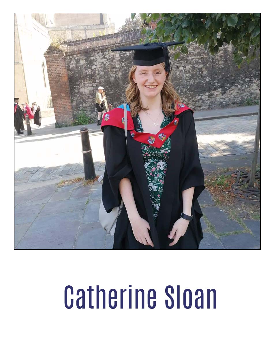 Graduate Catherine Sloan standing in graduation robes outside Rochester Cathedral