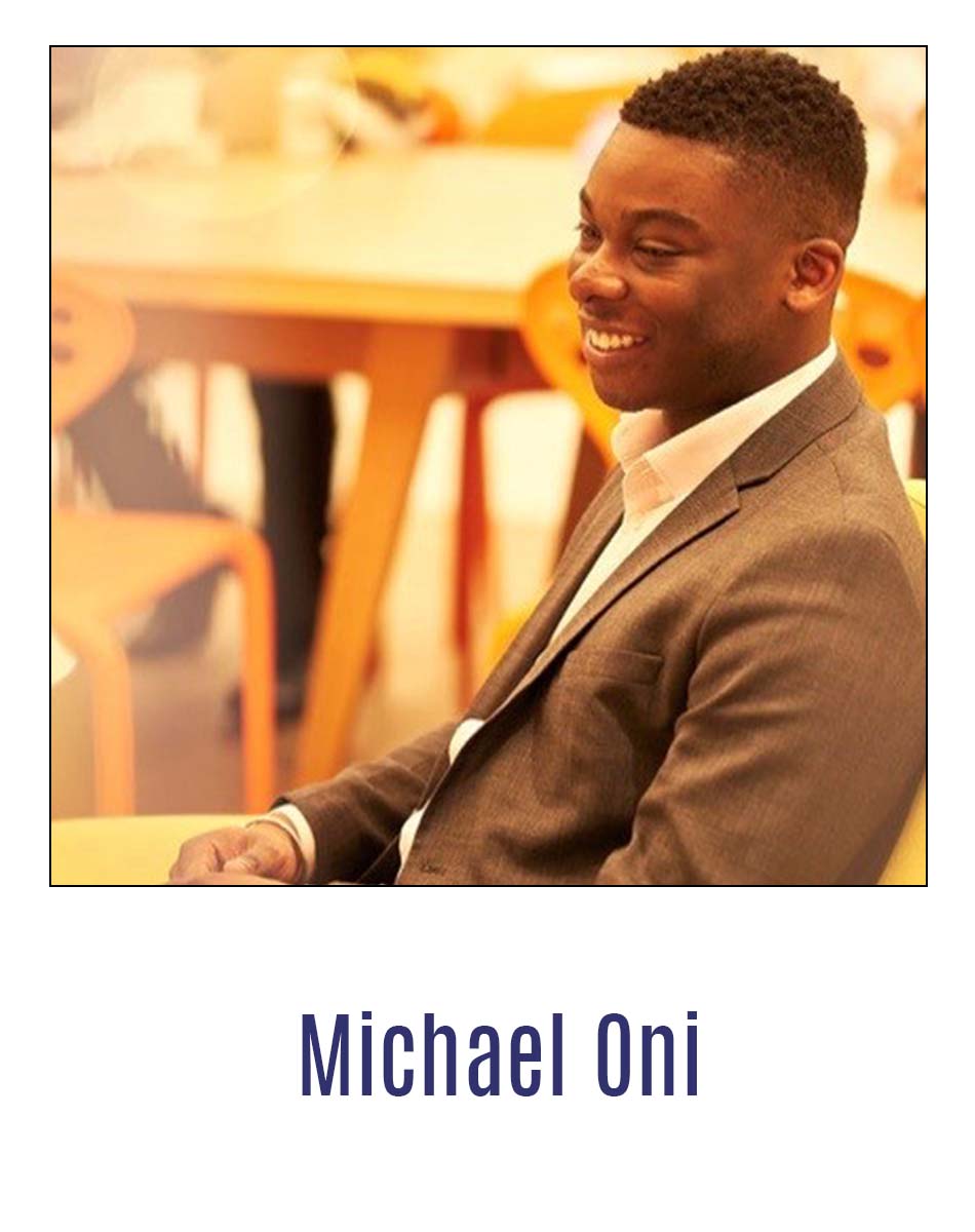 Graduate Michael Oni sat at a table smiling